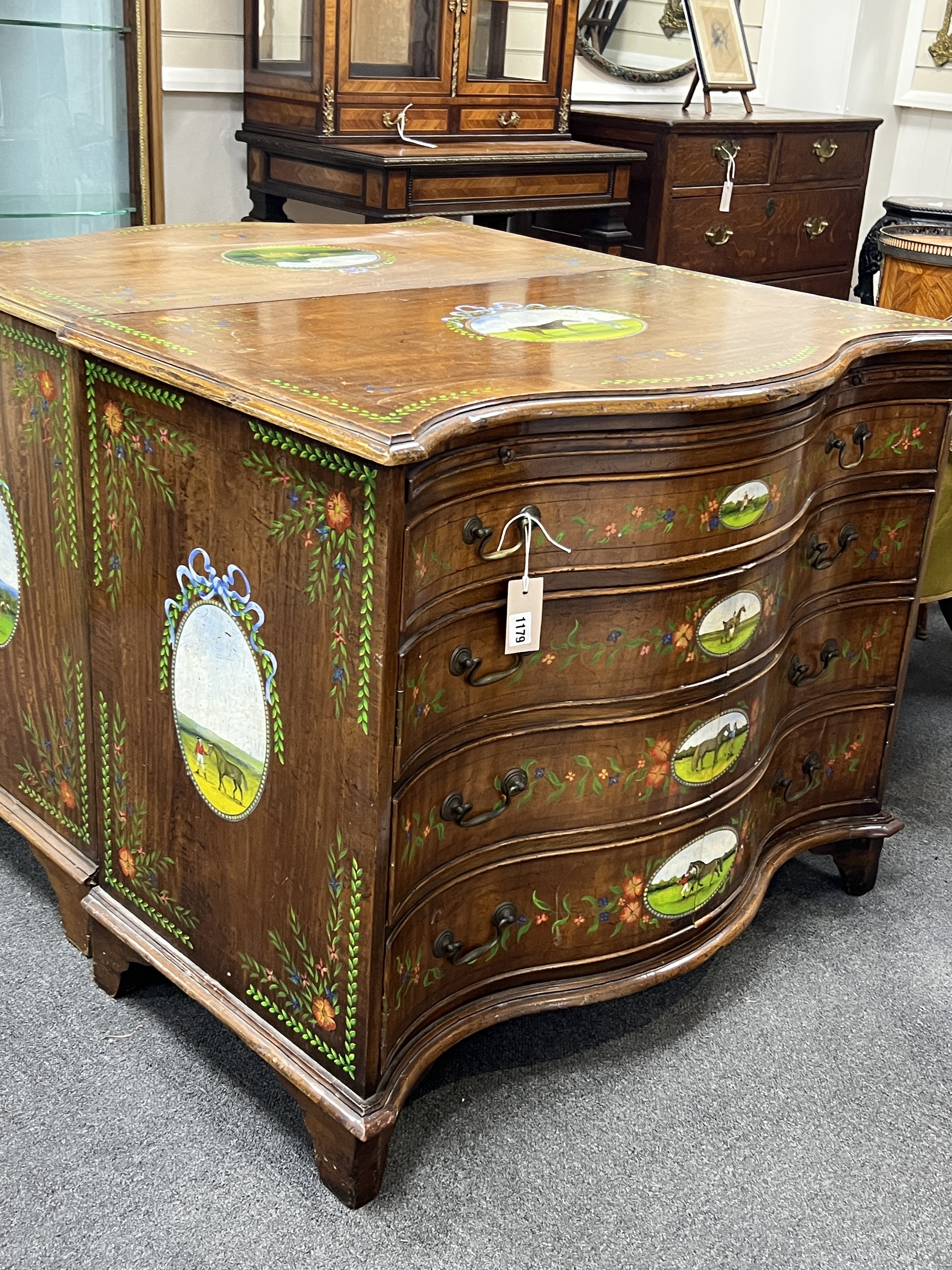 A George III style painted satinwood serpentine chest with part dummy drawer front, width 91cm, depth 48cm, height 75cm